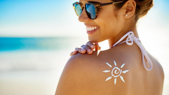 Woman at the beach with sunscreen on - Low Country Dermatology - Savannah, GA